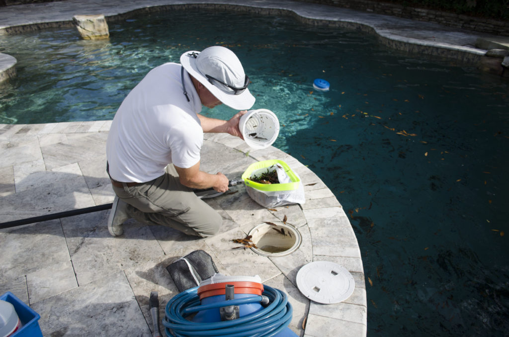 Man cleaning pool